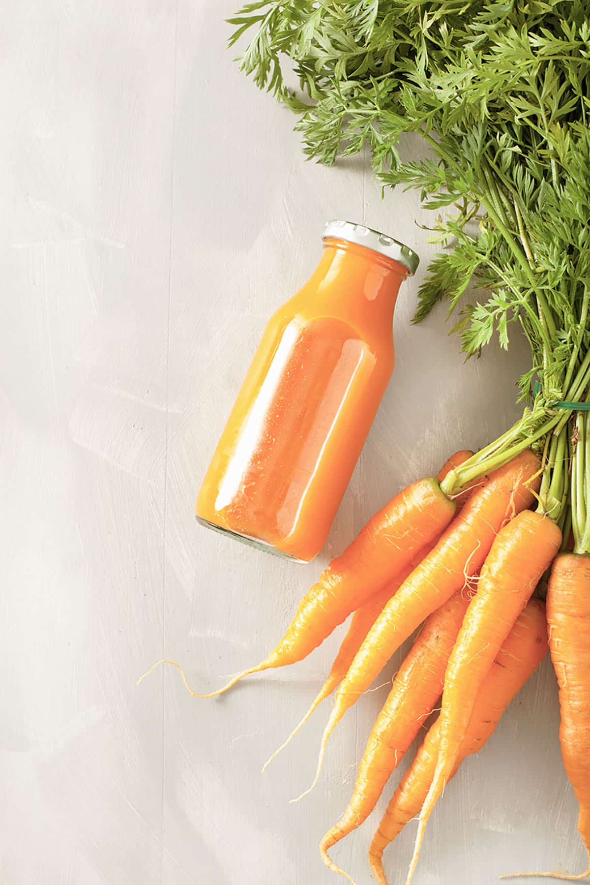 fruit and vegetable smoothie in glass jar, orange carrot