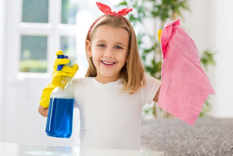 little girl with cleaning supplies