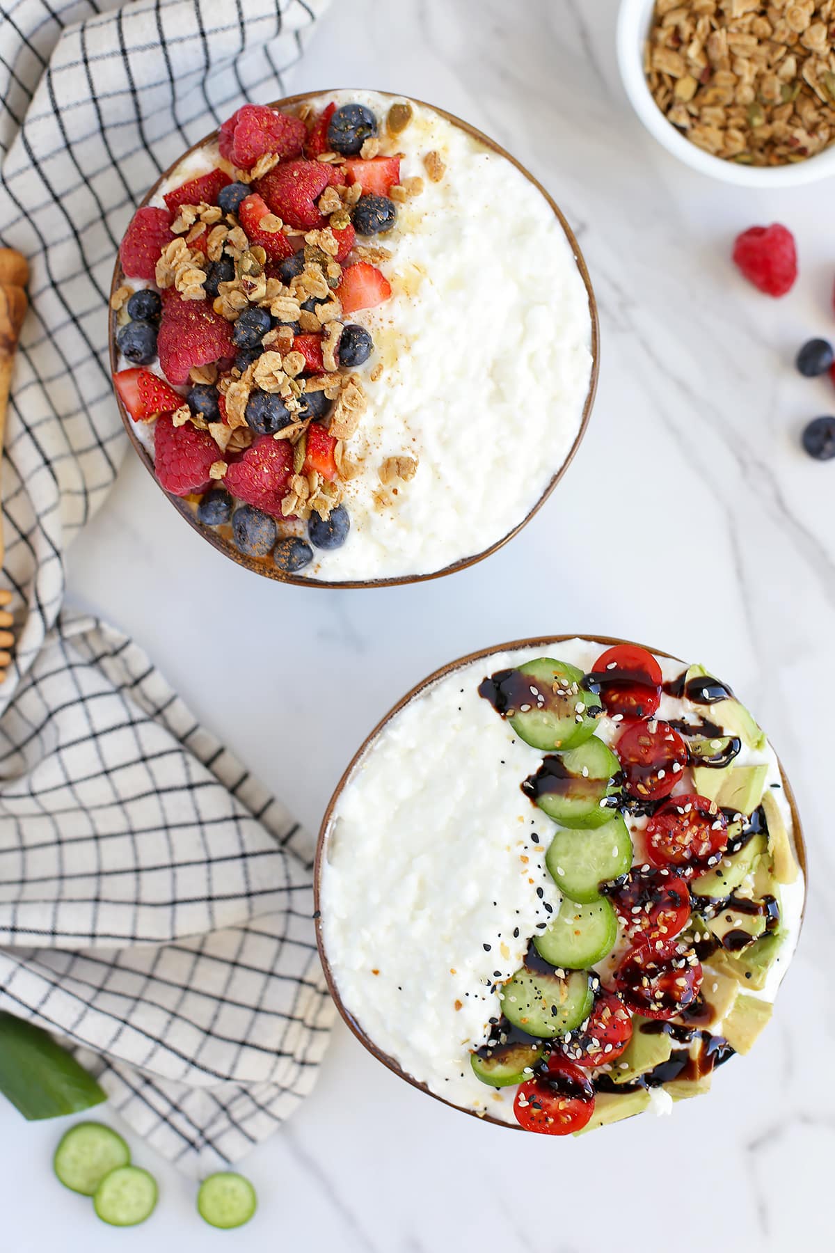 two bowls of cottage cheese  with toppings and a small bowl of granola on the side