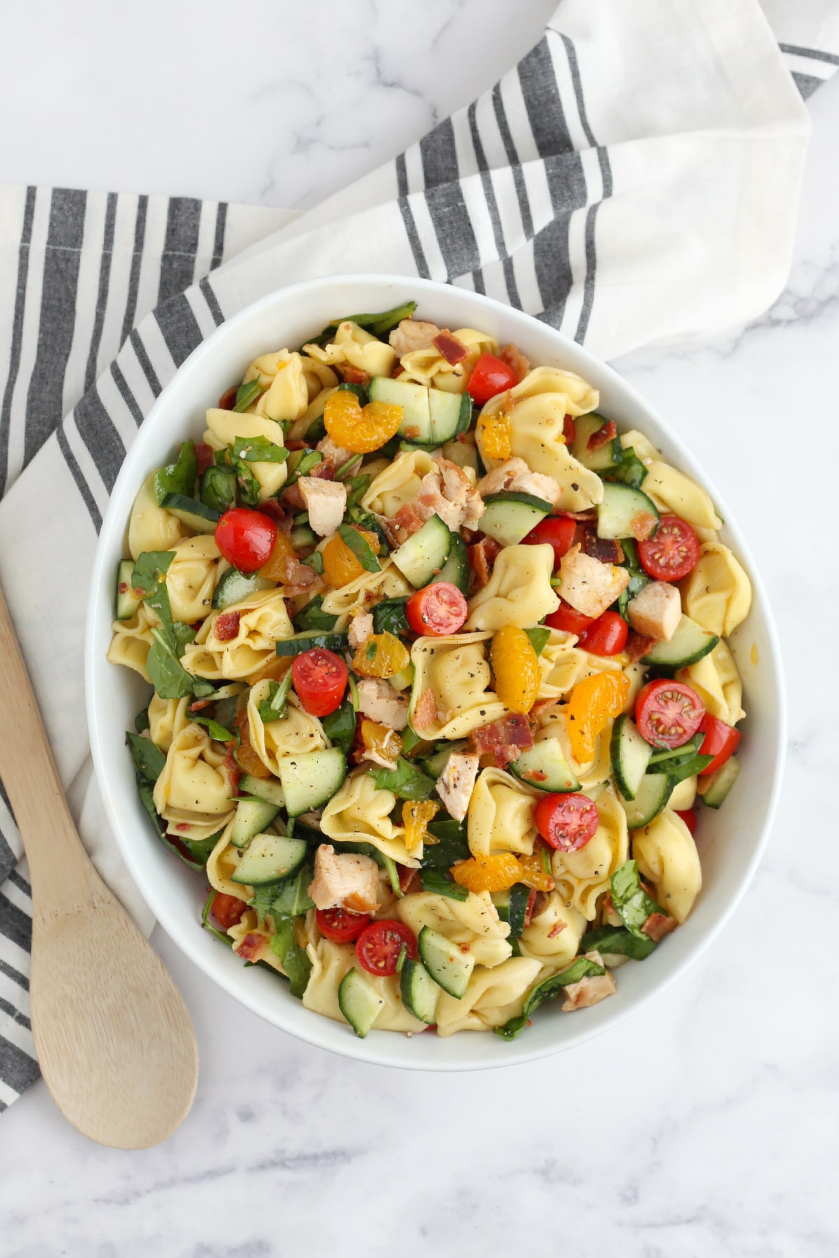 Tortellini pasta salad with fresh fruit and vegetables and tossed in a sweet and tangy dressing.